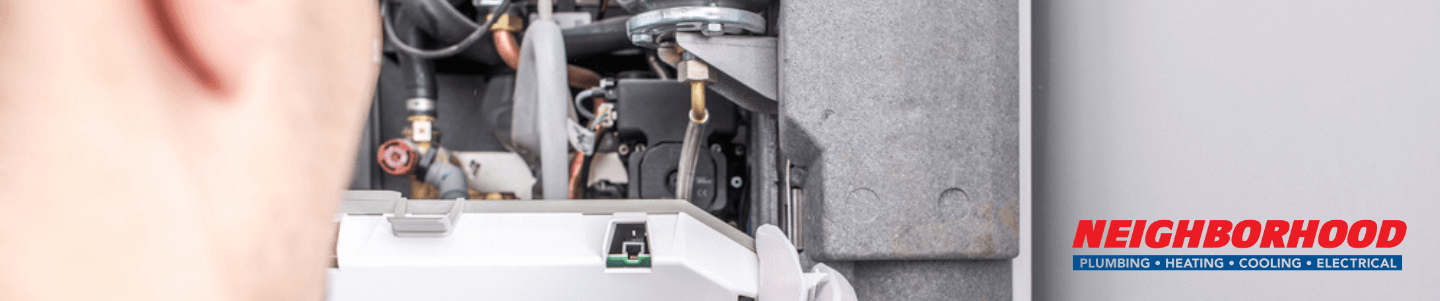 A technician re lighting the pilot light after a power outage.